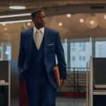 Actor Denzil Washington, wearing a naval three-piece suit, white tie and white dress shirt, held a Manila folder while walking through an open office in the scene of Spike Lee's latest action, up to 2. Washington plays music tycoon David King.