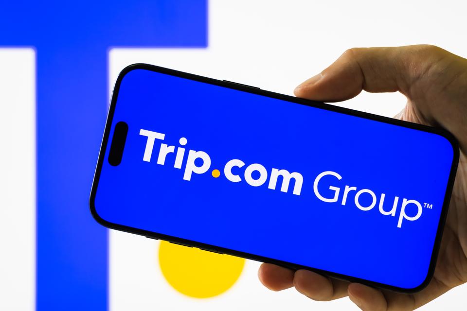 Trip.com group logo displays on smartphone screen