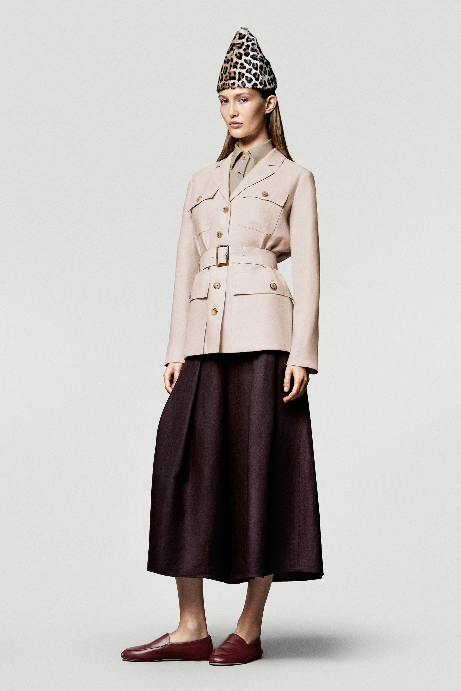 Images may contain clothing jacket adult skirt coat long sleeves and jacket