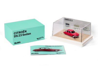 The box next to the lid contains a red hot wheel and a booklet. 
