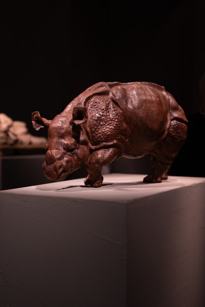 Brown rhino sculpture on pedestal