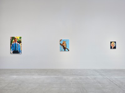 There are three paintings hanging on the wall.