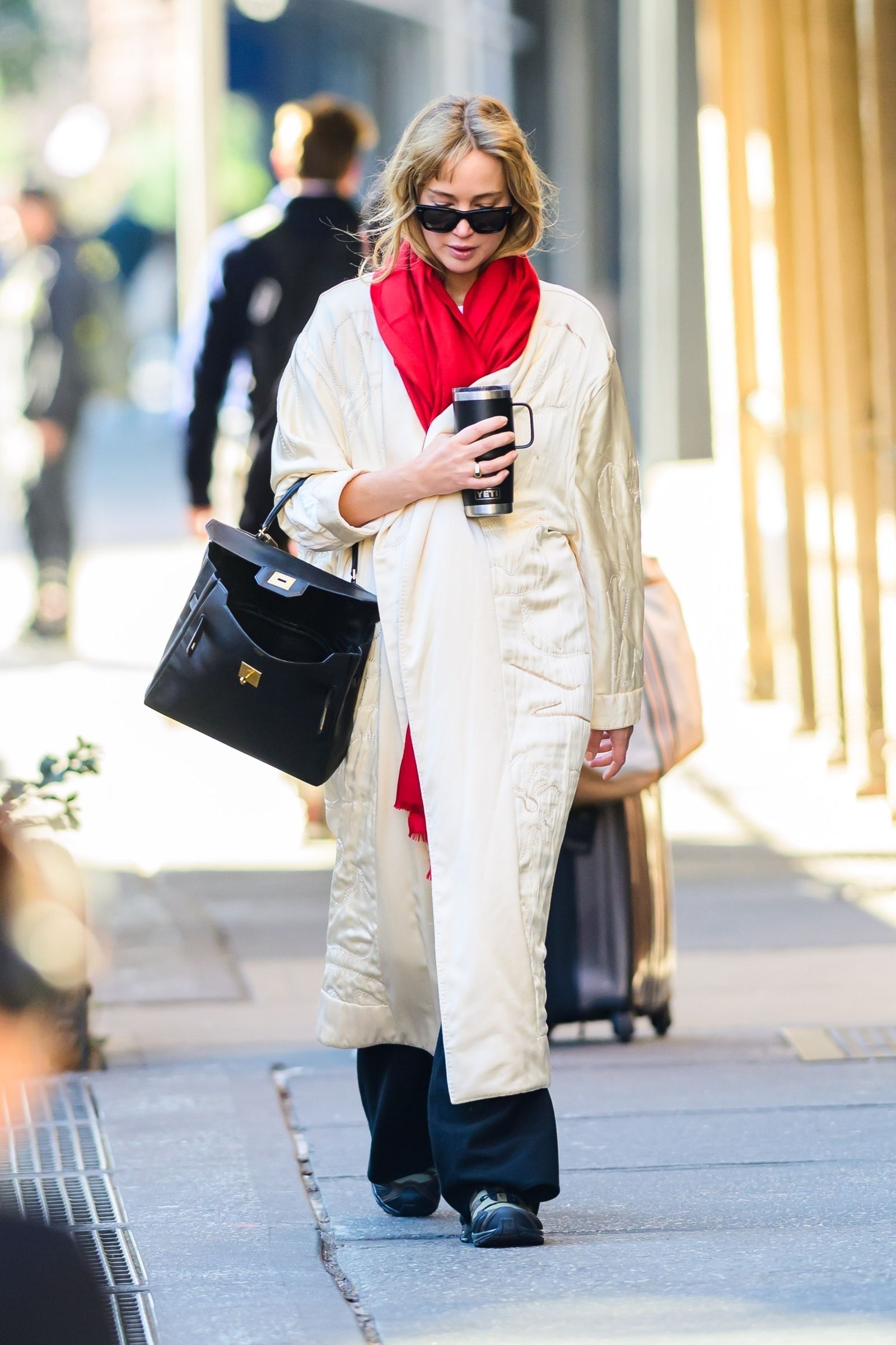 New York Exclusive Jennifer Lawrence leads a new fall trend with an earthy red oversized scarf that combines...