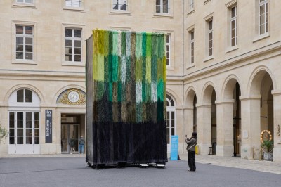Tall green and yellow textiles in the square.