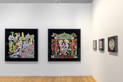 A booth with paper-cut artworks depicting men kissing.