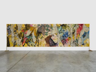 A large abstract painting with ropes on the sides.