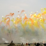 Under a gray sky, the view of the fireworks display was dominated by oranges and yellows.