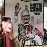 CHICAGO, IL - MAY 20: Fans take photos of a mural of Pope Leo XIV during a rain-delayed game between the Seattle Mariners and Chicago White Sox at Fetter Field on May 20, 2025 in Chicago, Illinois. (Photo by Jeff Stelfox/Getty Images)