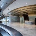 Staff are seen at the reception of The Henderson, a new skyscraper designed by Zaha Hadid Architects that will house Christie's new auction house, in Central, Hong Kong on July 25, 2024. While the global art market has retreated from its pandemic-era highs, the world's three largest auction houses are racing to expand in Hong Kong, eager to attract young Asian buyers. In the space of two months, Sotheby's, Christie's and Bonhams will each witness the culmination of years of efforts to upgrade their regional headquarters in the southern Chinese city. (Photo: Isaac Lawrence/AFP) / Paired with: Hong Kong-China-Economy-Auction-Art, 