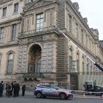 French police stand next to the furniture elevator used by robbers to enter the Louvre Museum on the banks of the François Mitterrand River in Paris, France, on October 19, 2025.