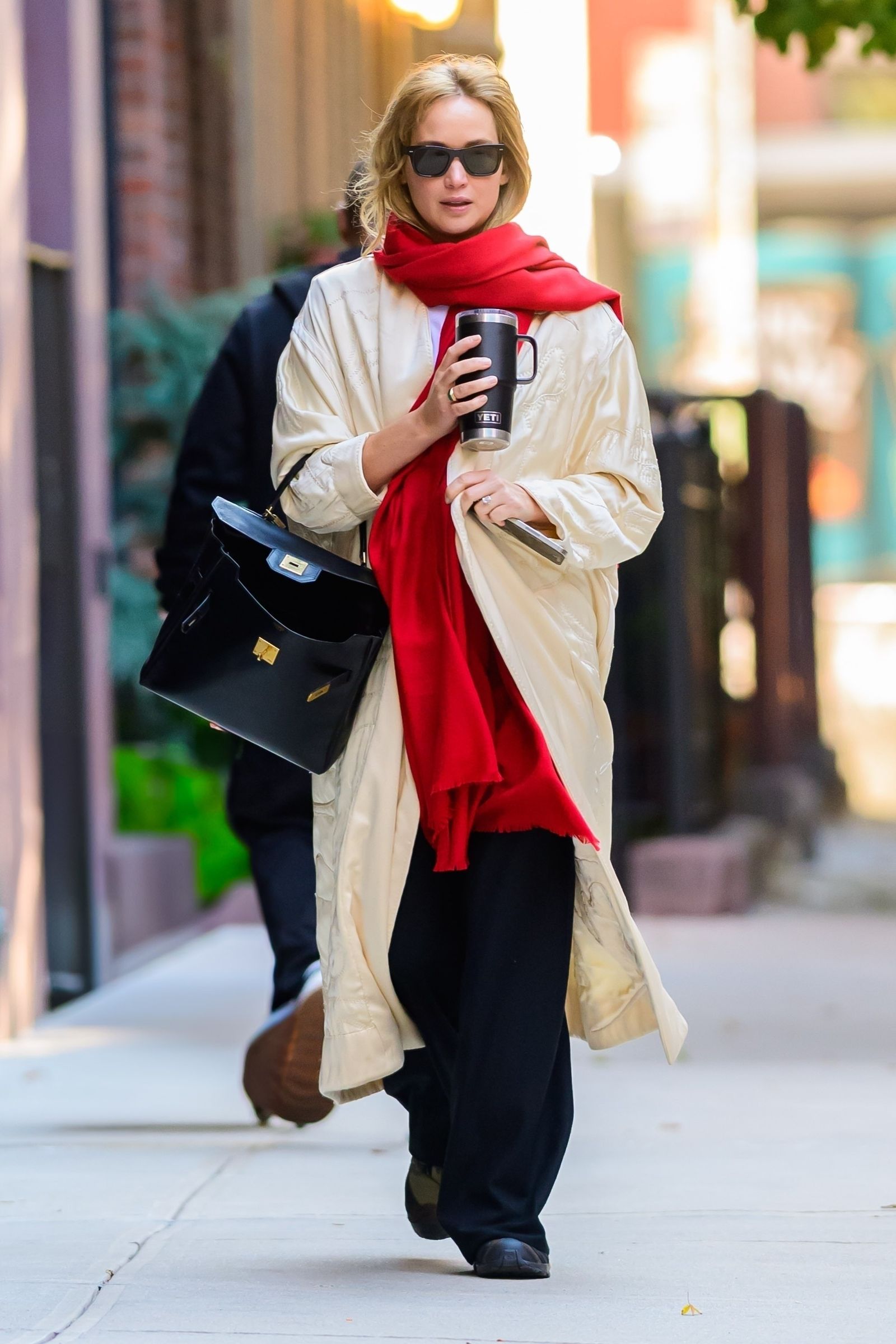 New York Exclusive Jennifer Lawrence leads a new fall trend with an earthy red oversized scarf that combines...