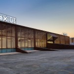 A modern rectangular building with floor-to-ceiling glass windows.