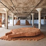 A sculptural landscape on display in an industrial space.