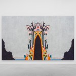 A colorful figure seemed to emerge from the ground in front of the gray sky.