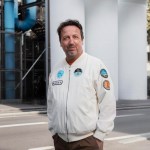Portrait of a man outside a building.