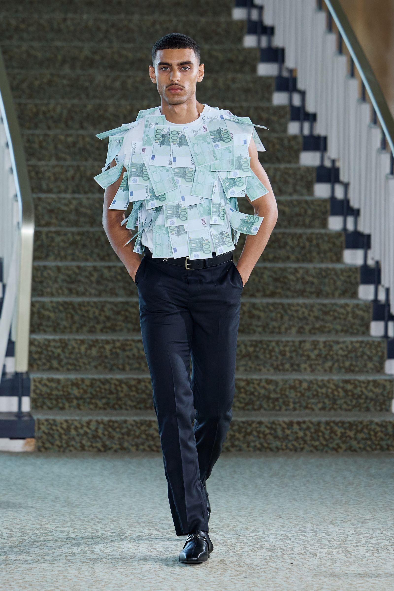 Image may contain clothing, pants, sleeves, adults, footwear, shoes, standing accessories and belts