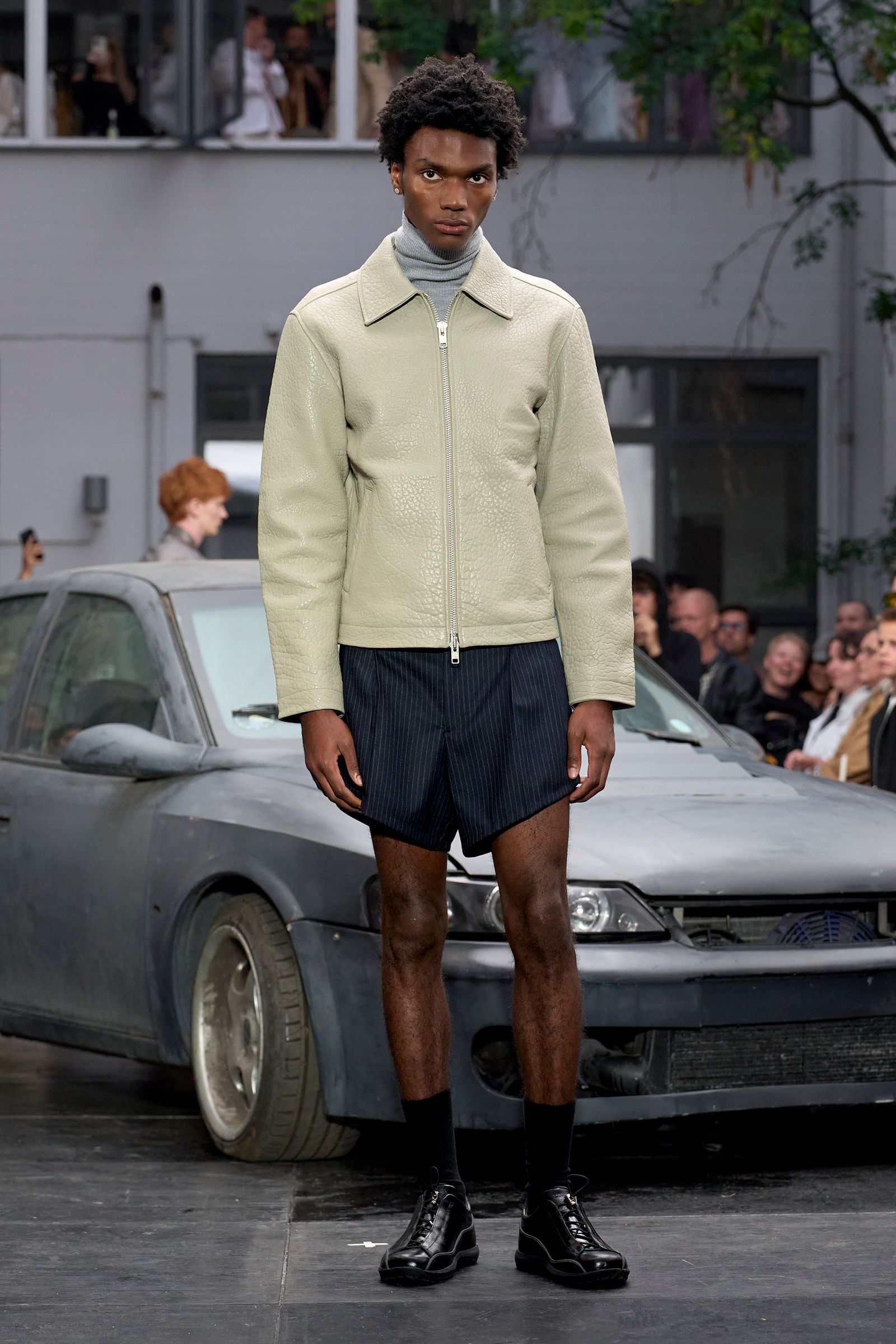 Image may contain clothing, shorts, person standing, adult car, transport vehicle, footwear and footwear