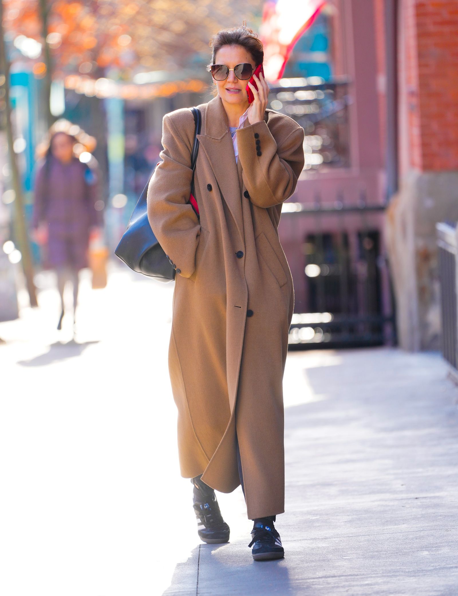 Image may contain Katie Holmes clothing, coat, accessories, bag, tote, coat, adult, face, head and glasses