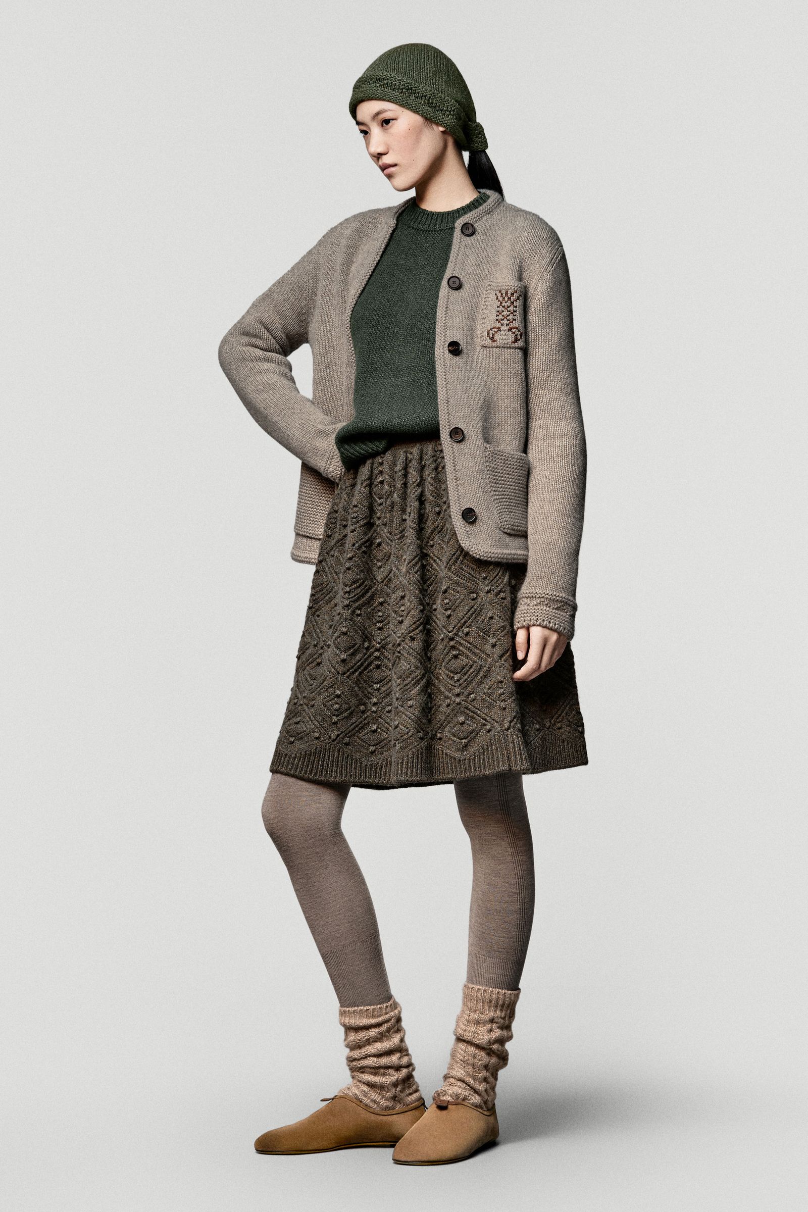 Image may contain Wang Beixing clothing, coats, knitwear, sweaters and people