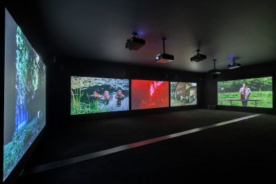 Multi-channel video installation in dark gallery.