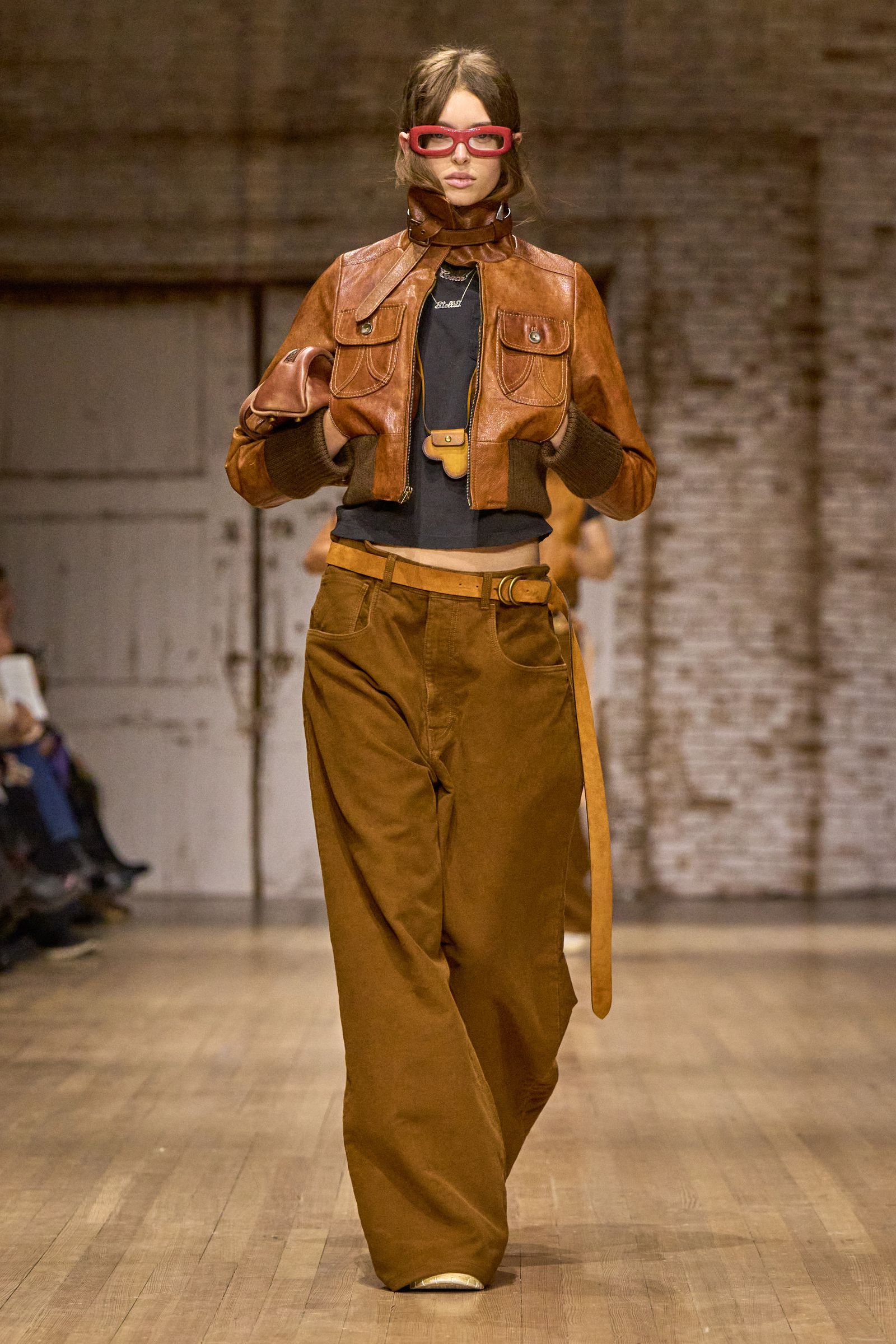 Image may contain clothing, coats, jackets, pants, fashion, adult accessories, belts, performers and solo acts