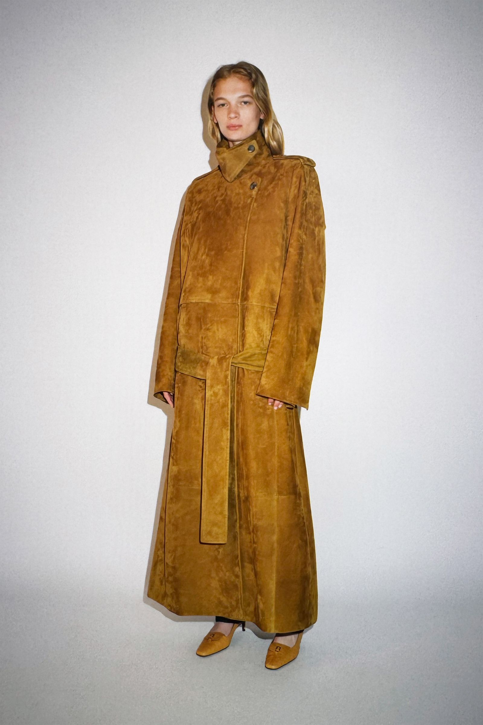 Image may contain clothing, outerwear, fashionable adult footwear, high heels and coats