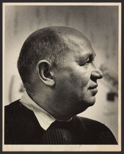 A vintage black-and-white photograph of Romare Bearden.