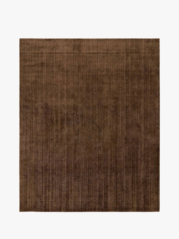 Image may contain: home decor, rug, books and publications