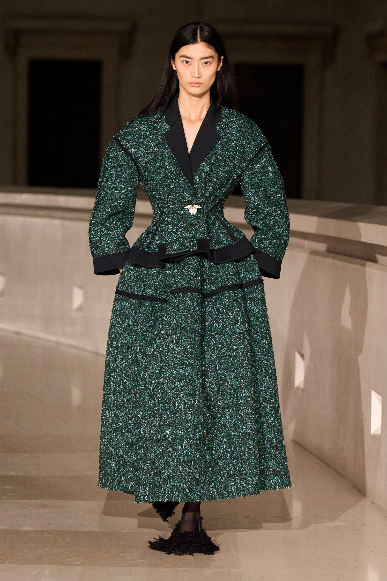 Image may contain Sonny Zhou character clothing, dresses, adult outerwear, formal accessories and belts