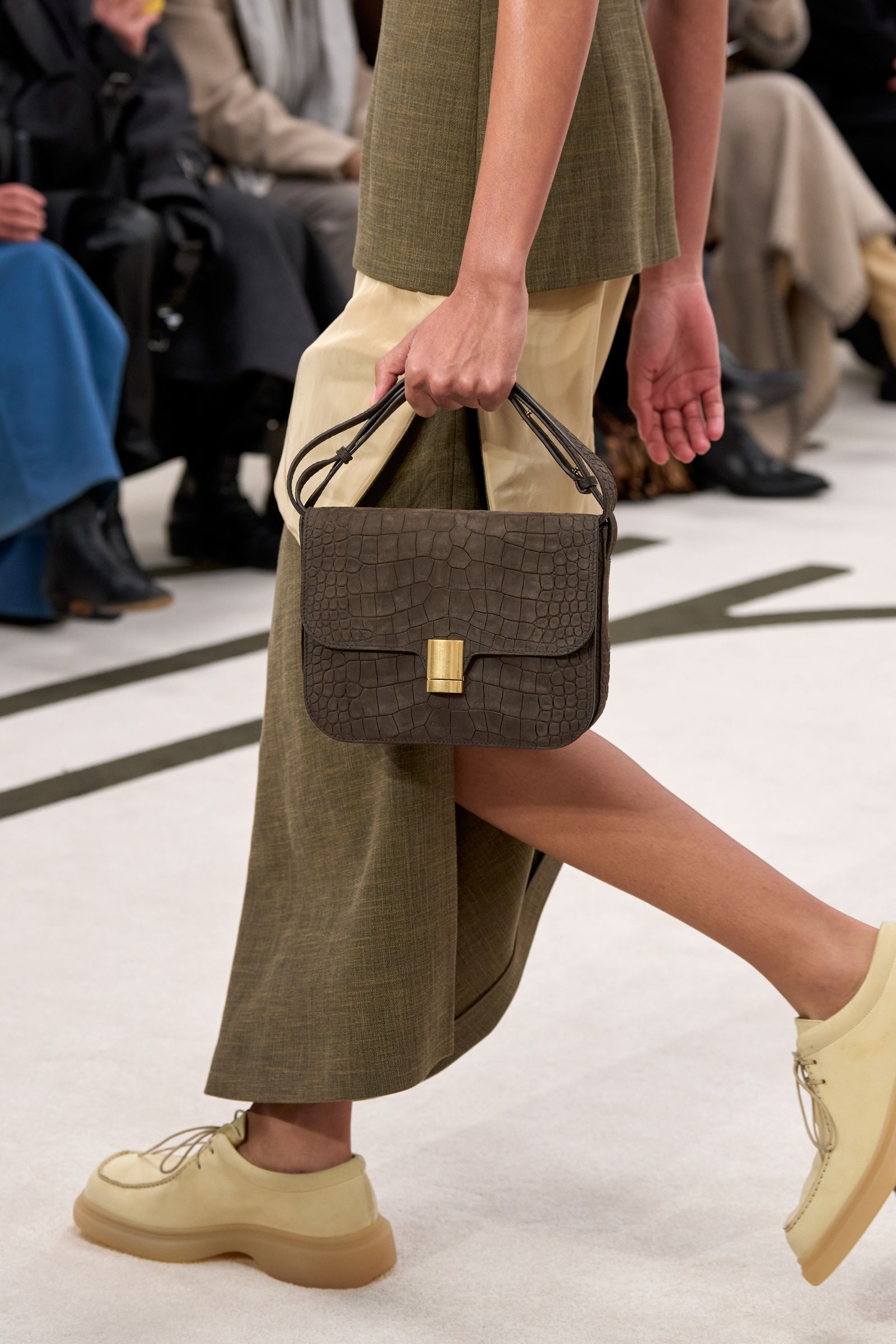 Image may contain clothing, footwear, footwear, accessories, bags, handbags, adults, sneakers and sandals