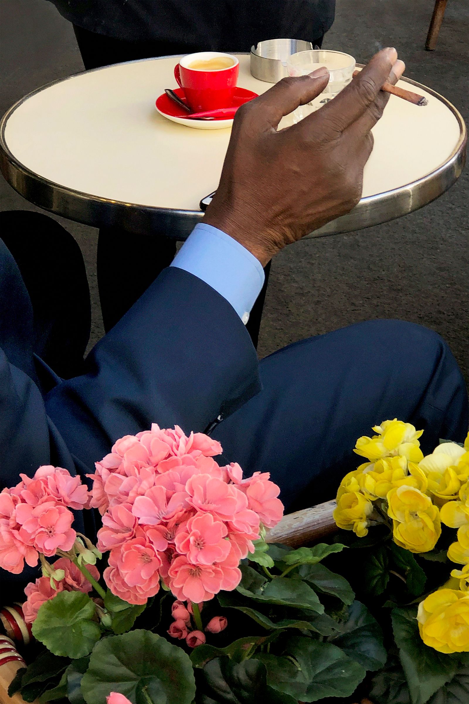 Image may contain furniture, table, flowers, petals, plants, adults, drinks, coffee and coffee cups