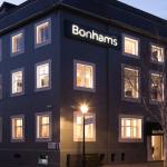 Buildings at night, lights shining through the windows.