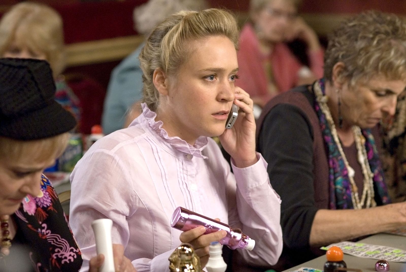 Image may contain Chloë Sevigny's head, blonde hair, electronics, mobile phone, phone bottle and shaker bottle