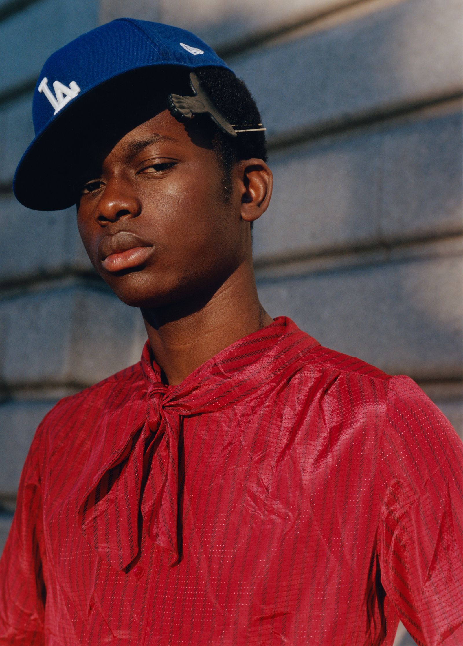 Image may contain baseball caps, hats, clothing, hats, people, human heads, faces, teen photography, portraits and body parts