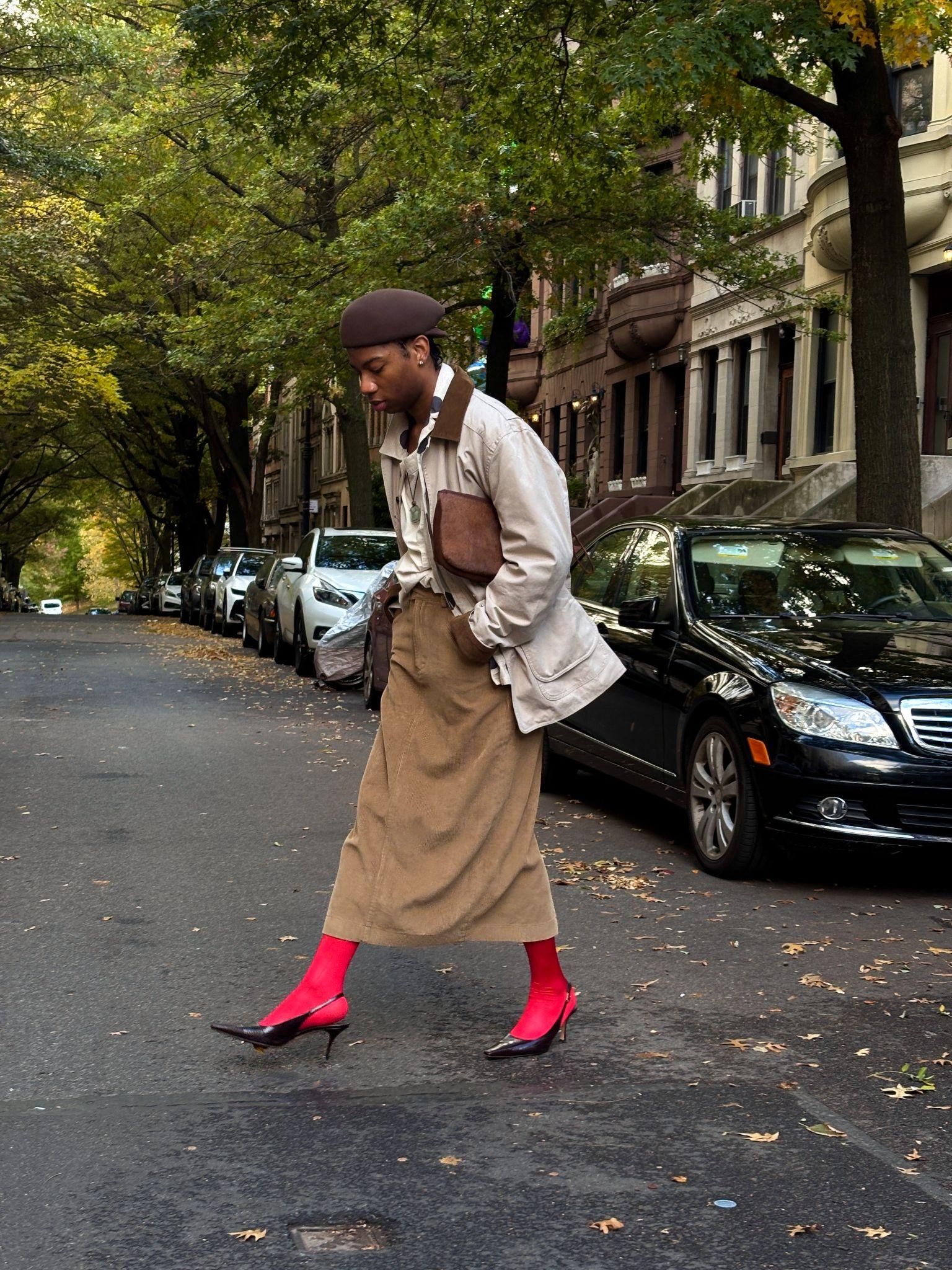 Image may contain people, pedestrians, adult accessories, bags, handbags, cars, transport, clothing and outerwear