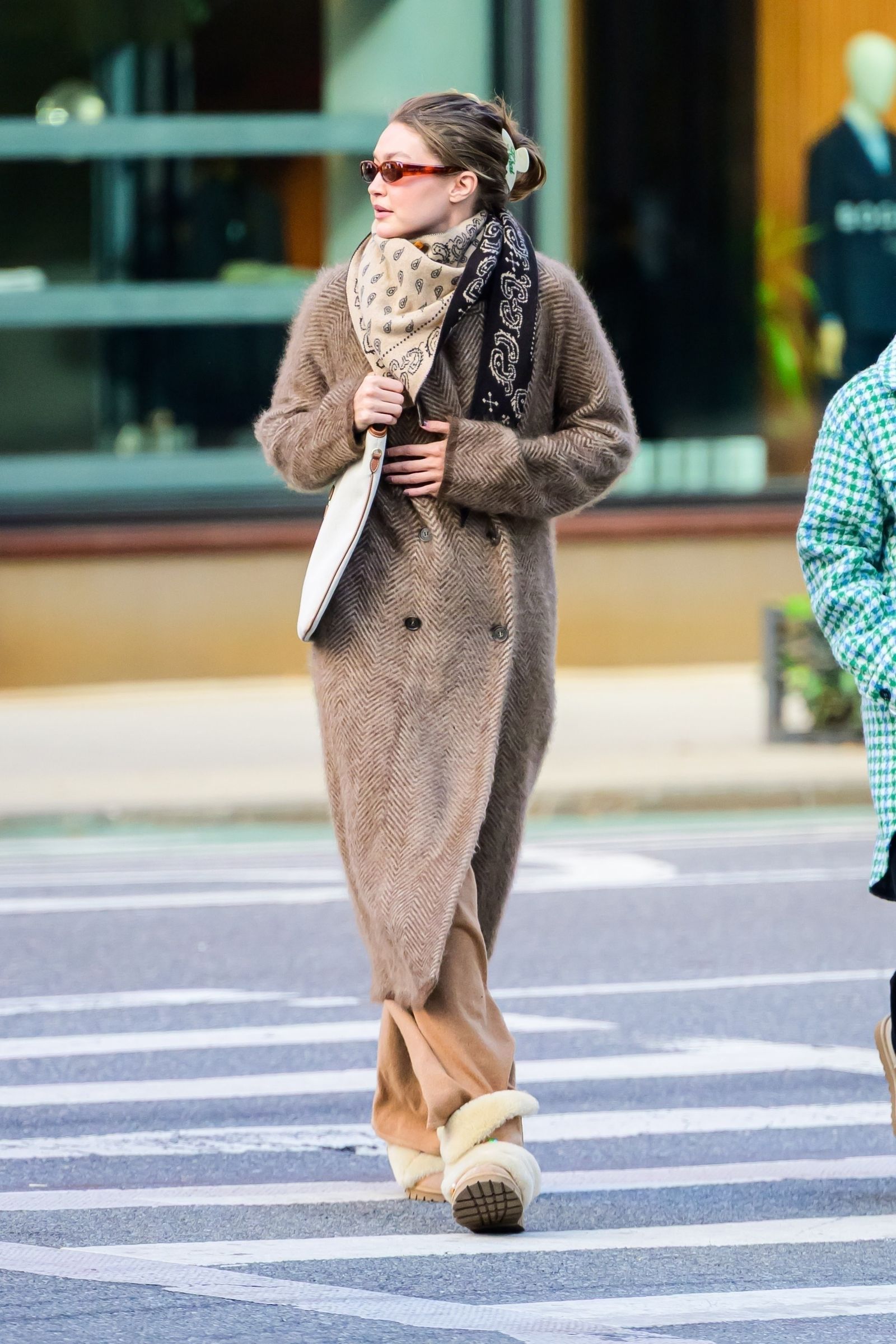 Image may contain Gigi Hadid pedestrian clothing outerwear adult coats and scarves