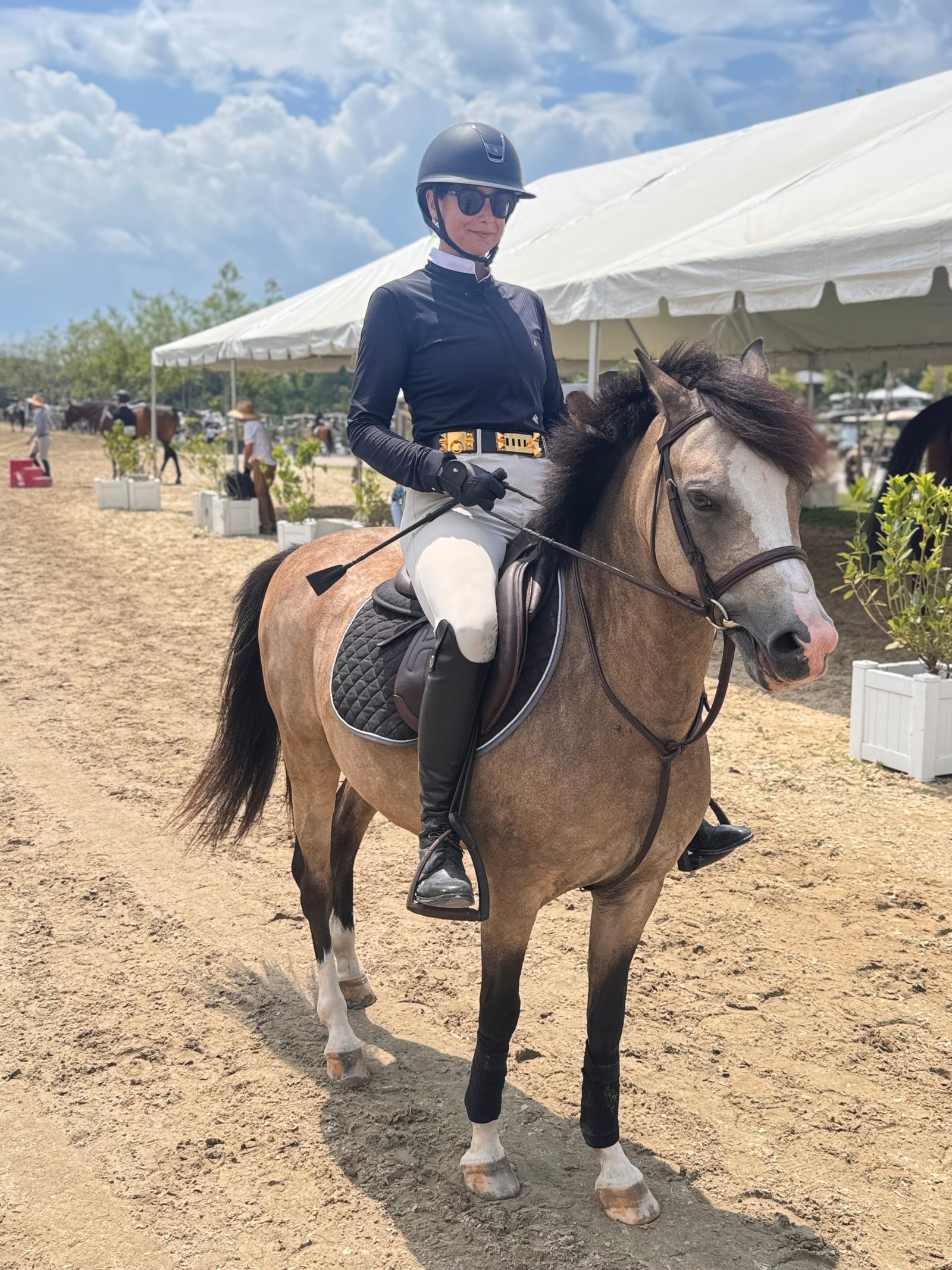 Image may contain animals, horses, horseback riding, leisure activities, mammals, people, adults, helmets, clothing and gloves