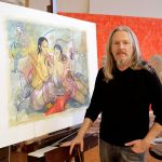 A man stands next to a painting on an easel.