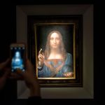 NEW YORK, NY - NOVEMBER 15: A visitor takes a photo of Leonardo da Vinci's painting 