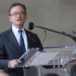 A man speaks at the podium.