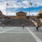 Two flags flutter on the stairs leading to the museum.