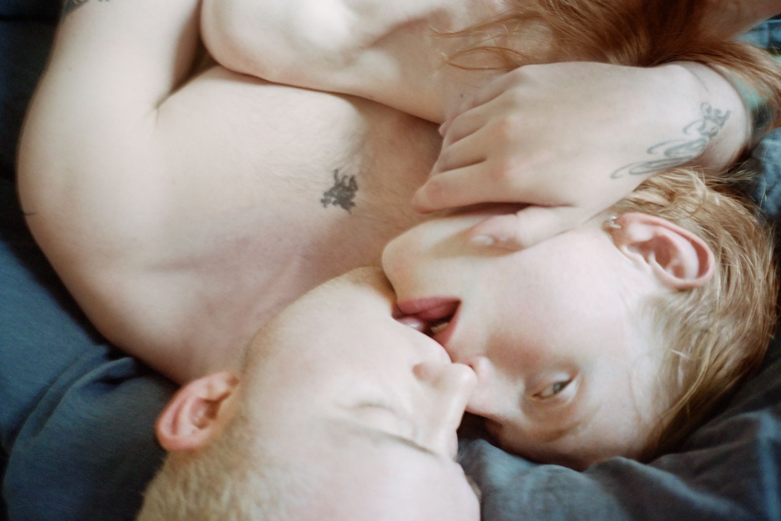 Sam Penn and Max Bartel kissing in bed