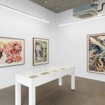 Gallery with paintings on the walls.