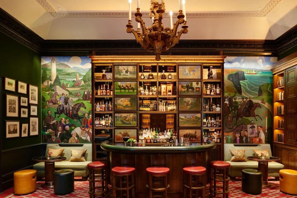 Image may contain chandelier, bar, people art, paintings, candles, animals, horses, mammals, alcohol and bar counter