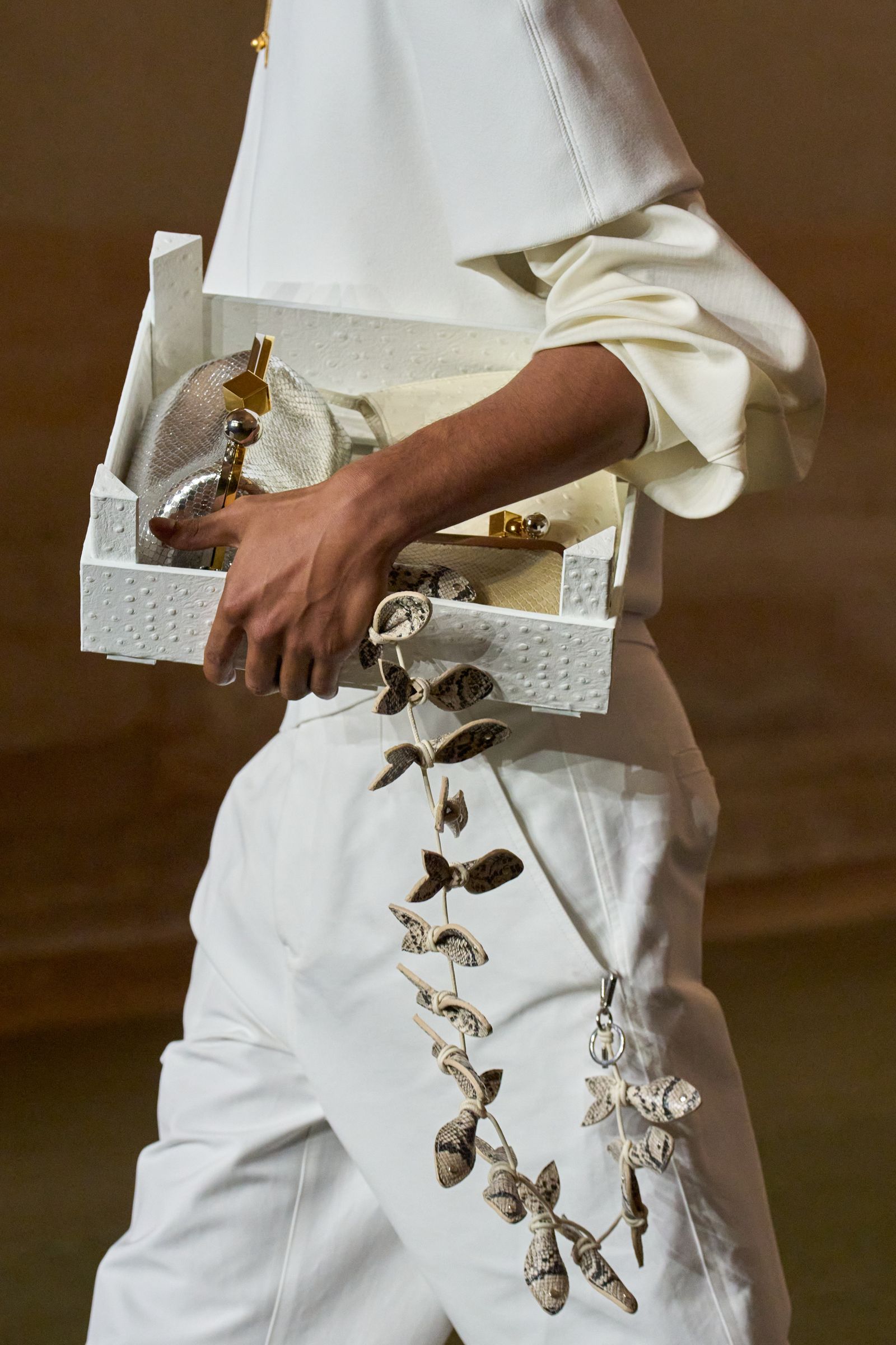 Image may contain Adult Person Body Part Finger Hand Sword Weapon and Accessories