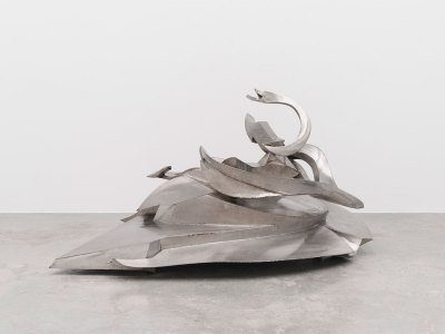 An abstract chrome sculpture that resembles a large pile.