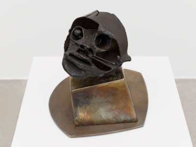 The sculpture shows a slightly bruised and disfigured face.