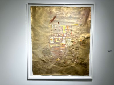 A golden painting of a ghostly house.