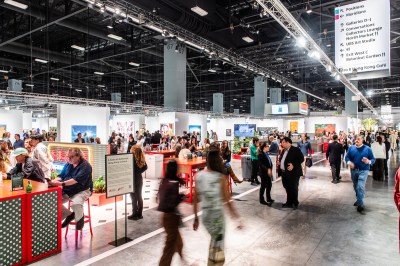 An art fair with people lolling on chairs.