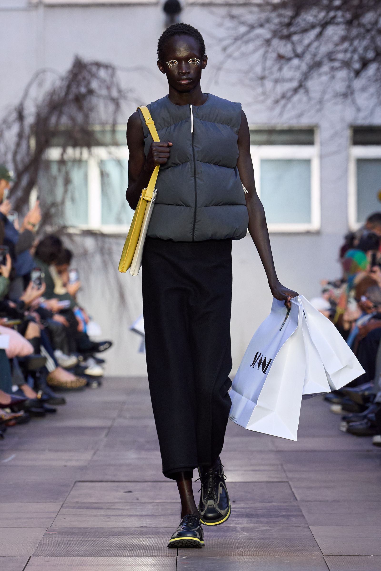 Image may contain Rebecca Nyandeng De Mabior Pedestrian Adult Clothing Footwear Shoes and Standing